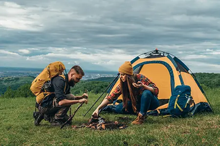 man and women camping outdoors